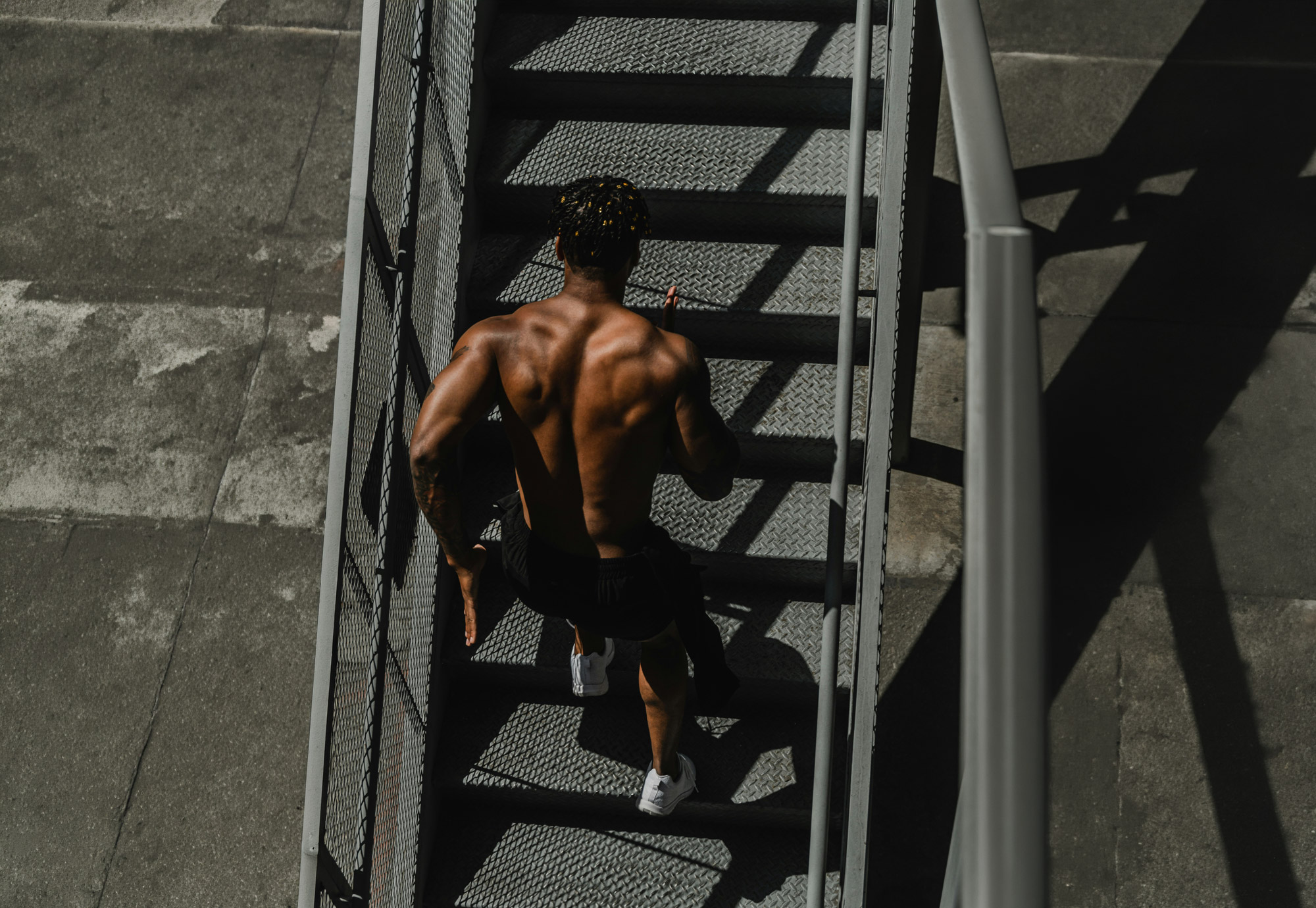 Athlete climbing an industrial staircase